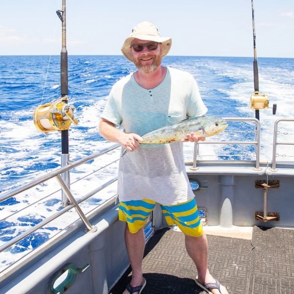 man-holding-fresh-caught-mahi-mahi-on-ocean Large